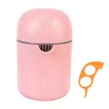 Image du presse agrume art déco de couleur rose avec un accessoire pour peler le fruit